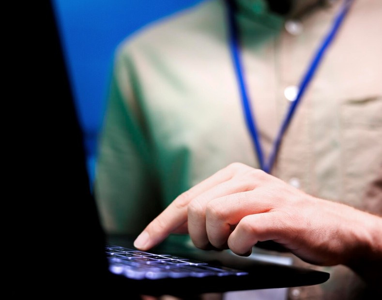 Remedy CMS technical support man with laptop